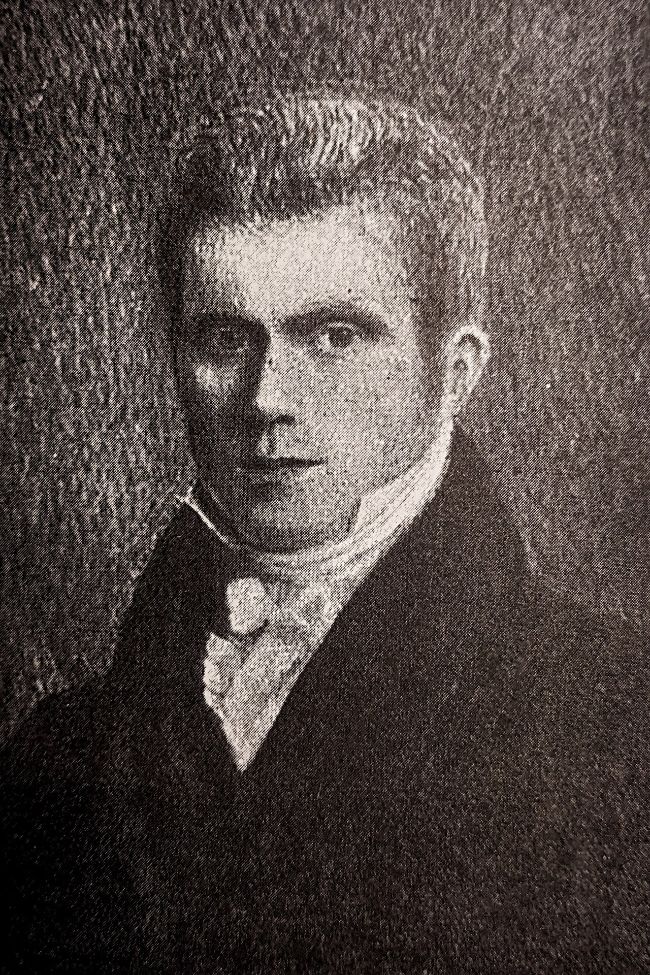 Grainy engraved portrait of a young man in a dark coat and high white collar