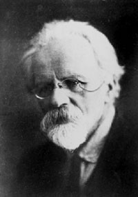 Black-and-white portrait of an elderly man with white hair, a white beard and pince-nez spectacles