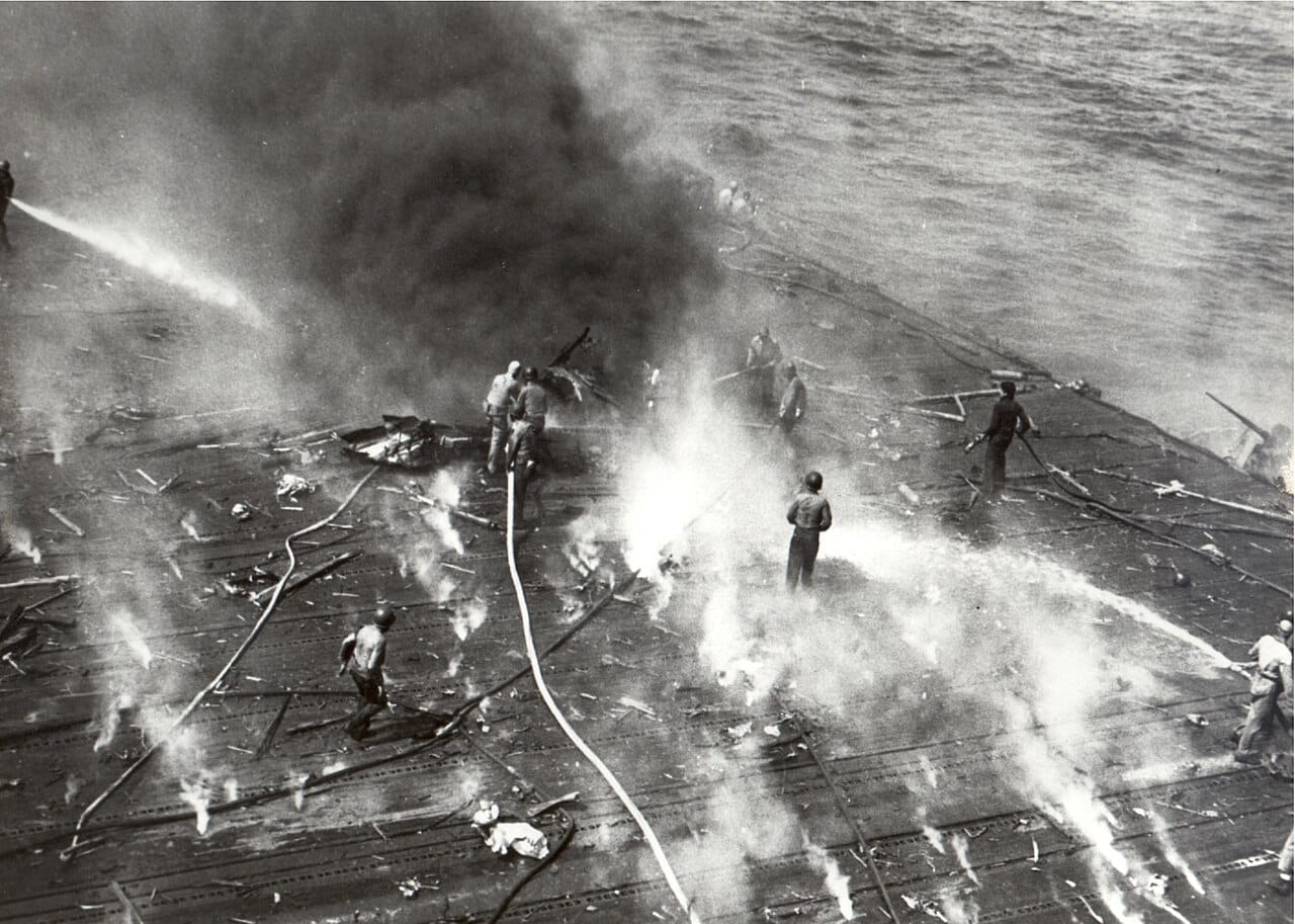 Black smoke pouring from the flight deck of the carrier USS Yorktown
