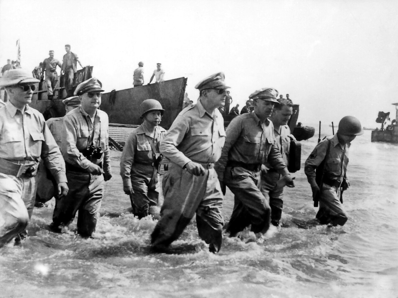 General MacArthur and officials wading ashore in knee-deep water