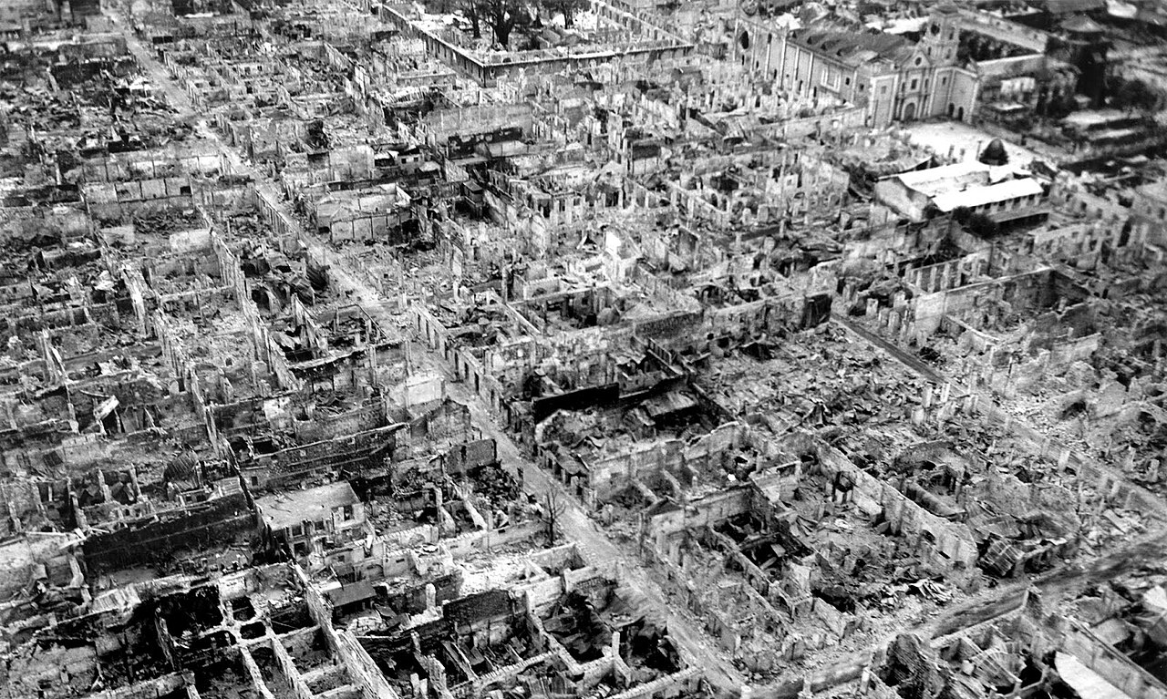 Aerial view of a walled district reduced almost entirely to rubble