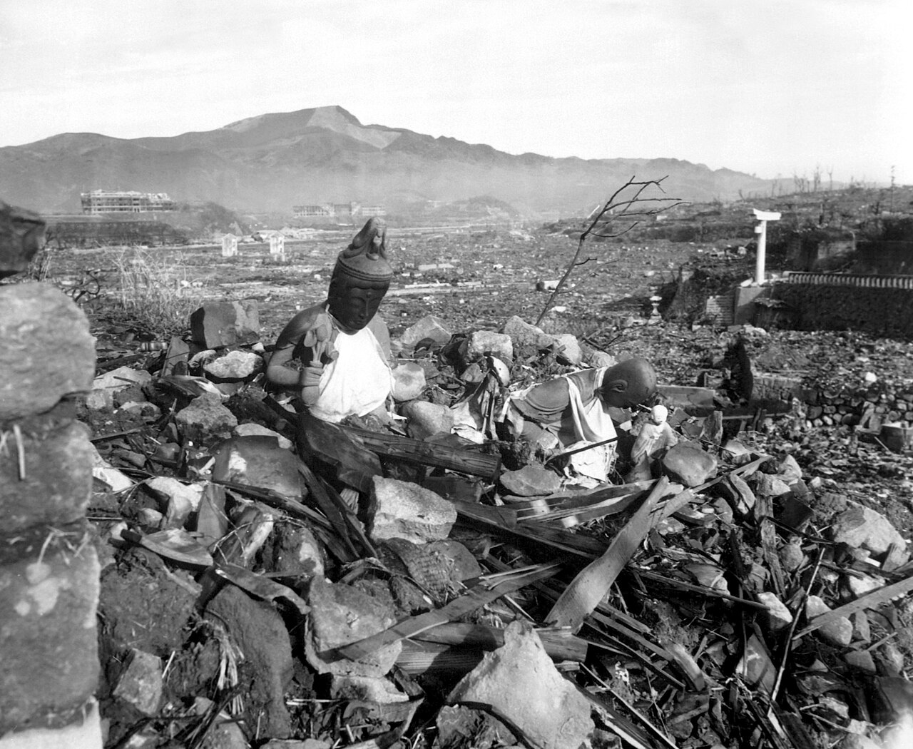 Battered stone religious statues standing above a flattened valley