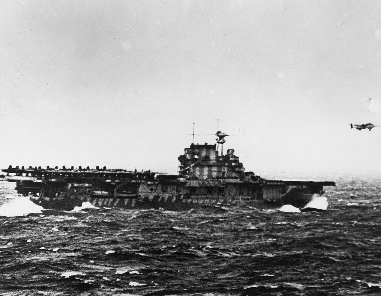 A B-25 Mitchell bomber lifting off the pitching deck of an aircraft carrier