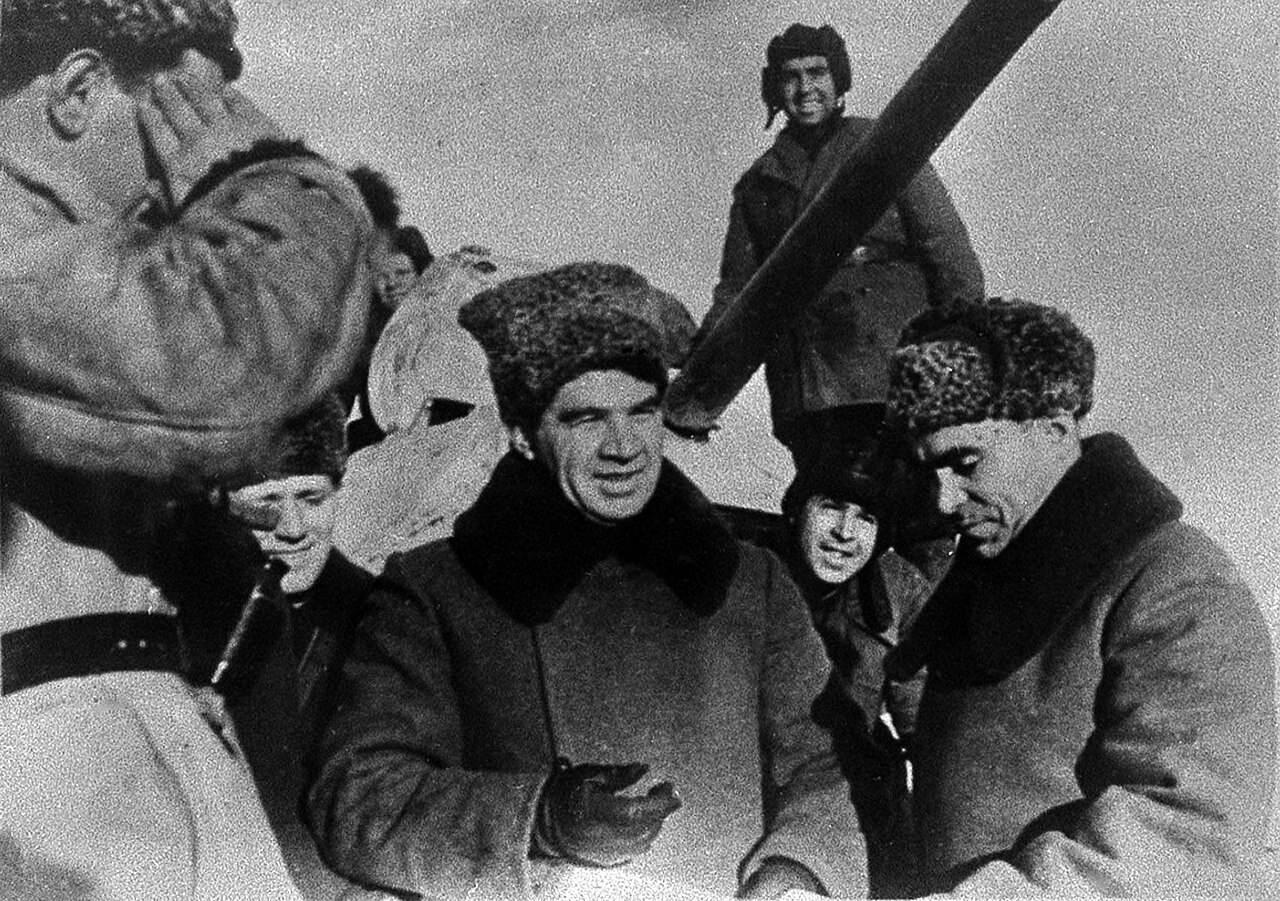 Soviet officers in fur hats conferring in a dugout